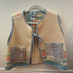 Rarely Used Item Has Been Worn A Few Times, But Still In Excellent Condition. Blanket Vest Hand Made By Olive Rose Studio In Montreal 100% Recycled Wool Blanket Cozy And Cropped A-Line Shape Layering Piece Made Of Thick Wool For Under Coats Or Over Sweaters Two Front Pockets And Bow At Front Fabric / Material 100% Recycled Wool Blanket Thick Wool Felt Vest, Handmade Vest, Patchwork Vest, Christmas Vest, Blanket Cozy, Fashion Things, Visible Mending, Thick Wool, Wool Vest