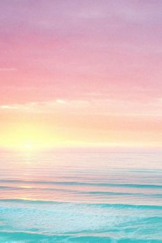 the sun is setting over the ocean with pink and blue colors