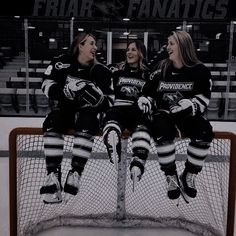 two female hockey players sitting on the bench