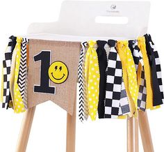 a wooden stool with a happy 1st birthday banner on it