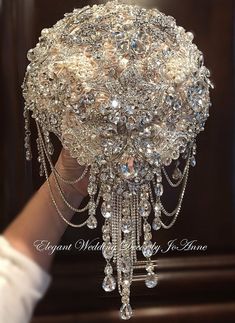 a close up of a person holding a chandelier