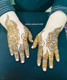 two hands with henna designs on them