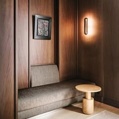 a couch and table in a room with wood paneling