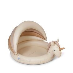 an inflatable unicorn laying on top of a banana shaped bed with its head sticking out