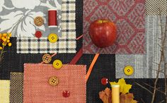 an apple and some sewing supplies on a table