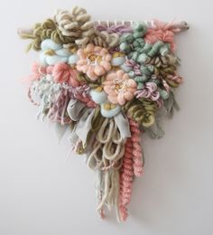 a bunch of different colored hair clips hanging on a wall next to a white wall