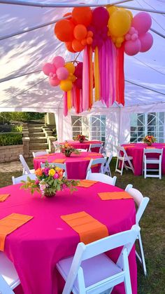 an outdoor tent with tables and chairs covered in pink, yellow and orange tablecloths