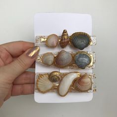 Elevate your beachy look with this set of 3 handmade natural sea shell hair clips. Embrace your inner mermaid with these golden barrettes, perfect for adding a touch of glamour to your beach wedding or Hawaiian luau outfit. Stand out at any ocean-themed festival with these unique accessories! Make a splash with these charming seashell hair clips. Handcrafted with love, this set of 3 barrettes will give your hair a touch of seaside charm. Whether you're attending a beach wedding or dressing up for a festival, these mermaid-inspired accessories are the perfect way to channel your ocean vibes. Add a touch of whimsy to your outfit with this set of 3 handmade sea shell hair clips. Featuring intricate details and a luxurious gold finish, these barrettes are the perfect accessory for your beach w Sea Shell Hair Accessories, Luau Costume, Shell Hair Clips, Seashell Hair, Wedding Ocean, Luau Outfits, Festival Art, Mermaid Inspired, Unique Accessories