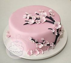 a pink cake with white flowers on it