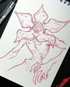 a drawing of a demon with red ink