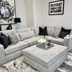 a living room filled with lots of furniture and pillows on top of it's couches