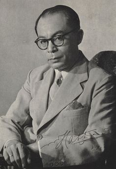 an old black and white photo of a man with glasses