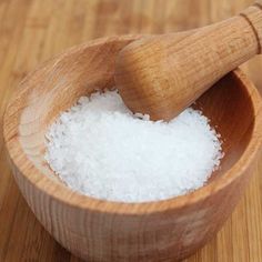 a wooden spoon with sea salt in it