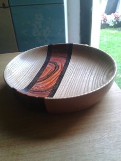 a bowl sitting on top of a wooden table