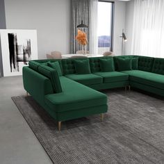 a living room with a large green sectional couch