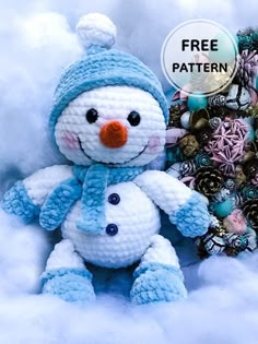 there is a crocheted snowman with a blue hat on it's head