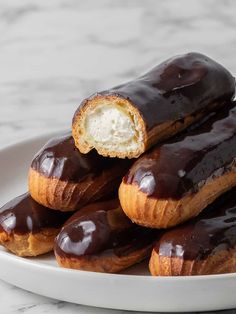 chocolate covered doughnuts on a white plate