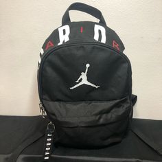 Black With Jordan Air Print On Top Two Zippers Black Letter Print Bag For Streetwear, Jordan Bag, Jordan Backpack, School Bag Essentials, Jordan Air, Jordan Black, Bag Essentials, Womens Jordans, Essential Bag