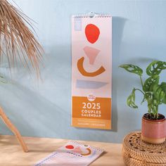 a desk with a plant and calendar on it