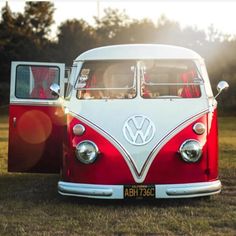 an old vw bus is parked on the gravel