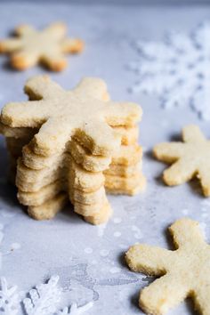 some cookies are sitting on a table with snowflakes