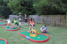 children playing in the backyard on mini golf mats