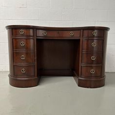 a wooden desk with two drawers on it