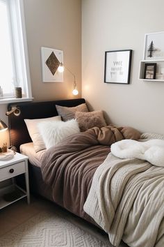 a bed with blankets and pillows in a bedroom