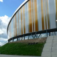 a large building with stairs leading up to it's sides and grass on the ground