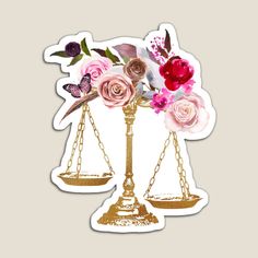 a scale with flowers and a butterfly on it