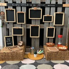 there are many pictures on the wall with chalkboards attached to them and some food in baskets