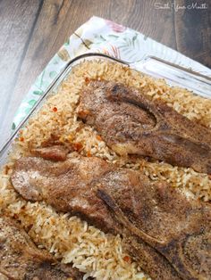 meat and rice in a glass dish on a table