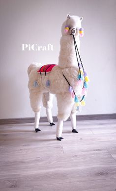 a white llama is standing on the floor