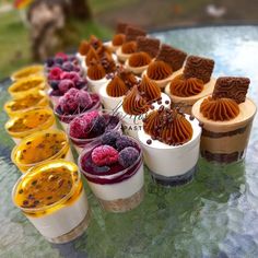 there are many desserts in cups on the table