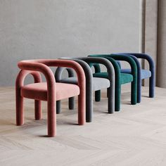 four different colored chairs sitting next to each other