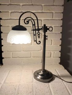 a lamp that is next to a brick wall