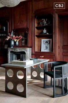 a living room filled with lots of furniture and wooden walls next to a fire place