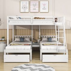 two white bunk beds sitting next to each other on top of a hard wood floor