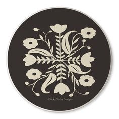 a black and white flowered design on a round sticker with the words,