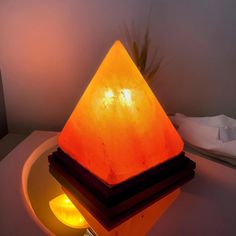 a pyramid shaped lamp sitting on top of a table