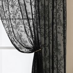 black sheer curtains with floral designs on them