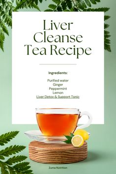 a cup of tea on top of a wooden table next to green leaves and a sign that says liver cleanse tea recipe