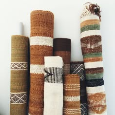 a group of different colored rugs sitting next to each other