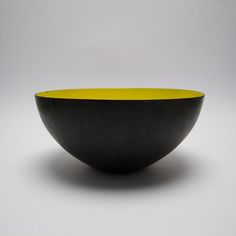 a black and yellow bowl sitting on top of a table