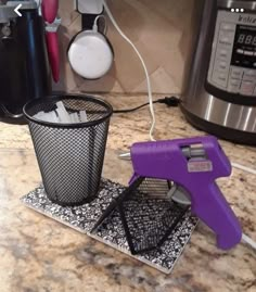 a kitchen counter with a purple and black device on it