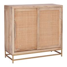 a wooden cabinet with wicker doors and metal legs