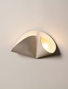 a light that is on the side of a wall mounted fixture with a white background