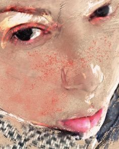 a close up of a child's face with red and white paint on it