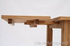 a close up of a wooden table with two pieces of wood attached to the top