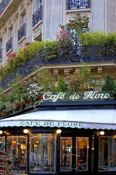 the outside of a building with plants growing on it's balconies and windows